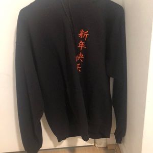 Black hoodie with white dragon design on the back